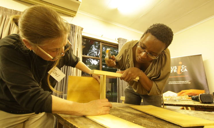 Trainees hard at work to build a marimba.