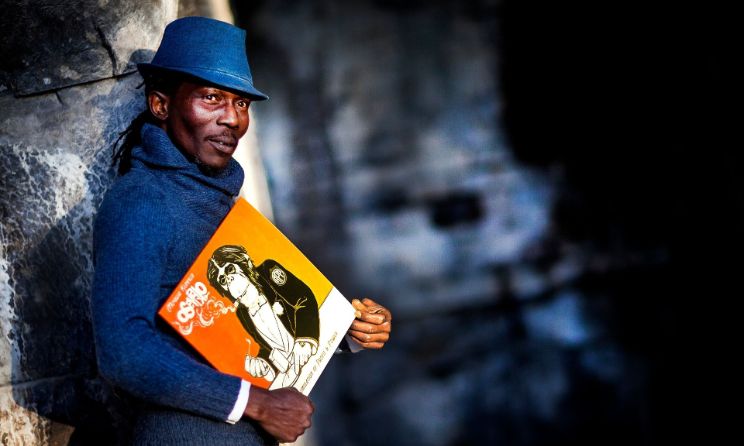 Muyiwa Kunnuji with the cover art of his new album ‘Accumulation of Profit and Power’. Photo: Stephane Barbier